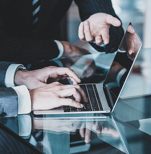 PCの前やり取りをする2人のビジネスマン